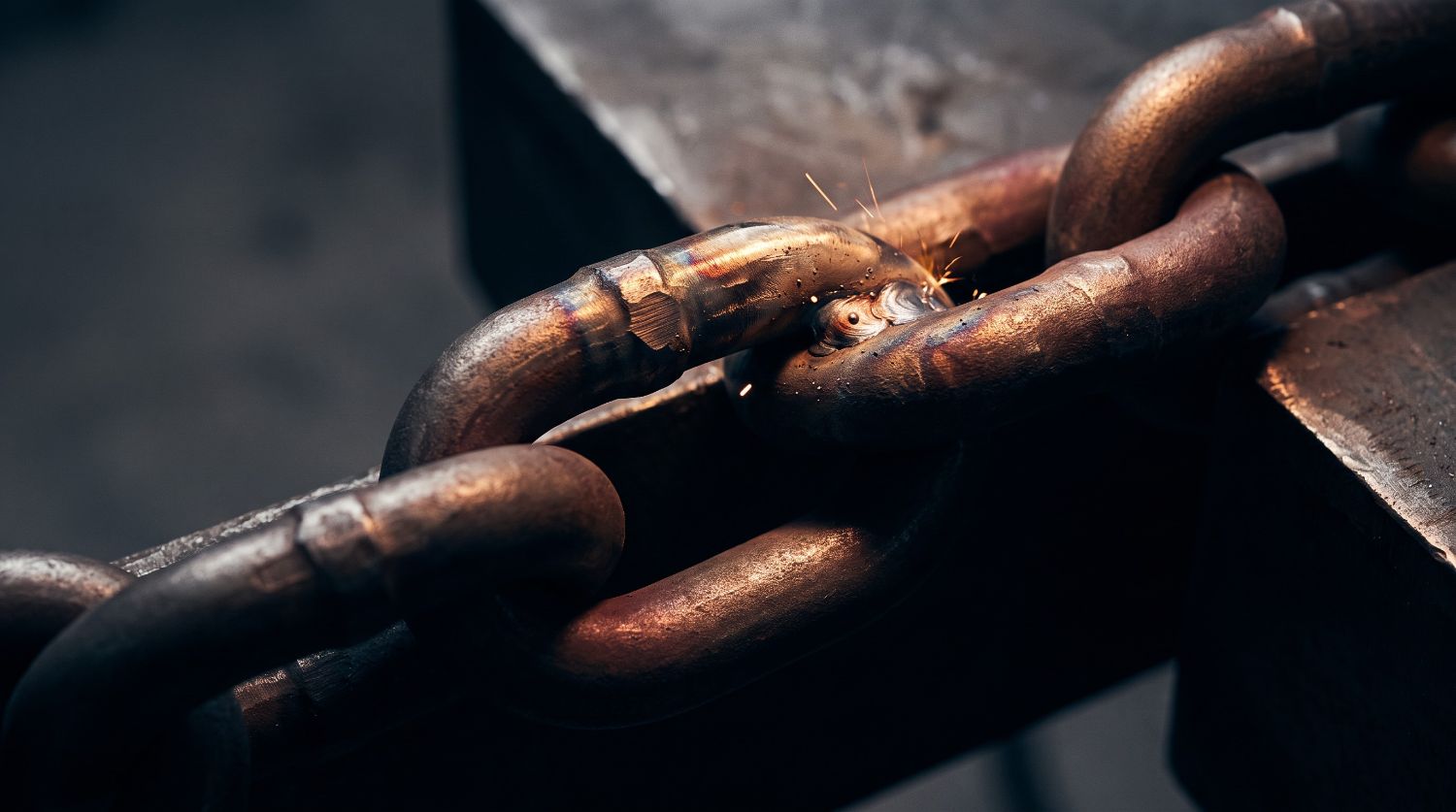 — a steel chain link under a work light